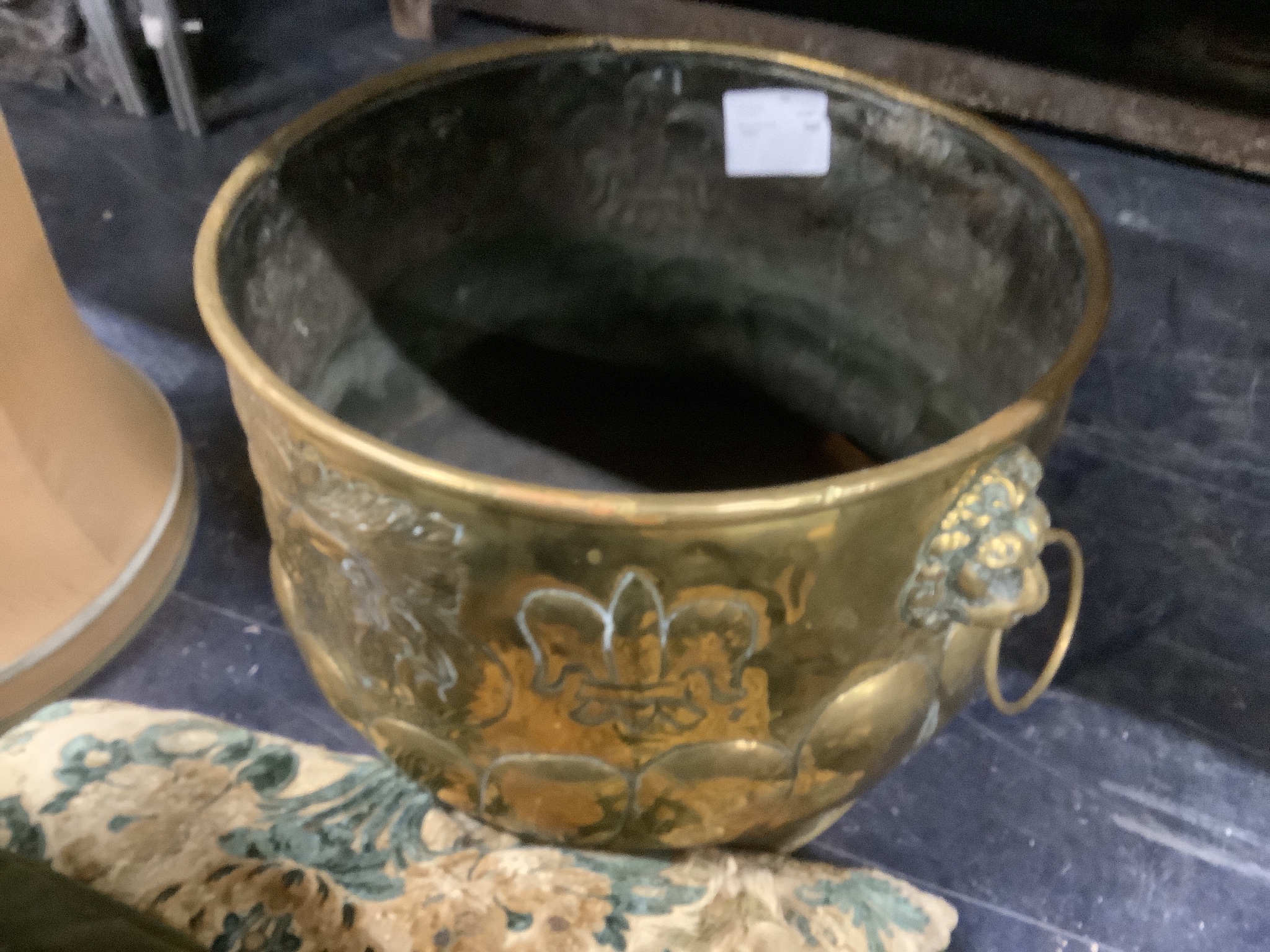 A 19th century circular Dutch embossed brass coal bin with lion mask ring handles, diameter 46cm, height 34cm